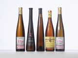 four bottles of wine are lined up on a table
