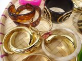 a tray with several different colored bangles on it