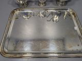 a silver tray with a silver handle on a table
