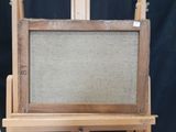 an old wooden easel with a painting on top of it