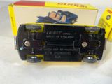 a black and yellow toy truck with a box in the background