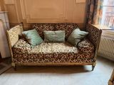 a leopard print couch in the corner of a living room