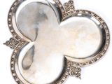 a picture of a silver plate with a flower on it