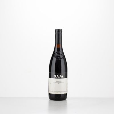 a bottle of red wine sitting on top of a table
