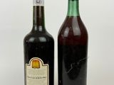 two bottles of wine sitting next to each other on a white surface