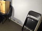 two chairs and a table in a room with a television