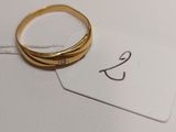 a gold ring with a diamond on top of it