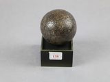 an image of a stone ball on a black stand