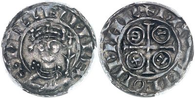 a close up of two silver coins on a white surface
