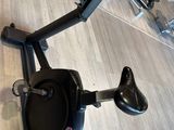 the exercise bike is sitting on the floor in the gym