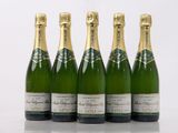 four bottles of champagne are lined up in a row