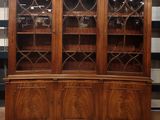 a large wooden china cabinet with glass doors and shelves
