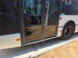a black and white bus parked on the side of the road