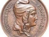 a close up of a coin with a woman ' s head on it