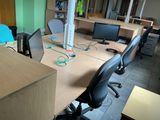 a desk with two computers and a monitor on it