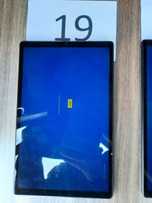 two ipads sitting side by side on a table with price tags on them