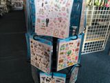 a cart with a bunch of stickers on it in a store