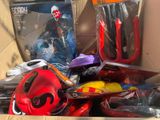 a cardboard box filled with assorted toys and other items