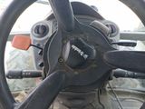 a steering wheel of a vehicle with a red handle