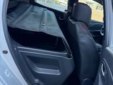 a car with the door open and the seats down