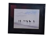 a picture of a group of people riding horses on the beach