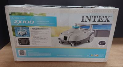 un carton contenant un aspirateur posé sur une table en bois