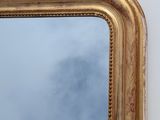 a mirror on the wall with a sky in the background