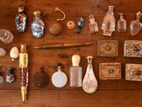 a wooden table with a lot of glass items on it
