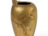 a gold vase with a bird on it on a white background