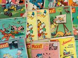 mickey and friends comic books stacked on top of each other