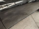 a black car parked on the side of the street