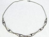 silver necklace with blue stones and silver chain on white background