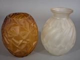 two vases sitting next to each other on a table