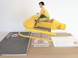 a figurine of a man riding on a yellow plane