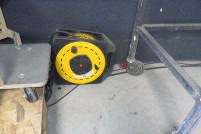 un compresseur d'air jaune et noir posé sur un plancher en bois