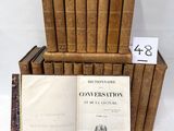 several old books stacked on top of each other on a table