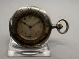 a silver pocket watch with roman numerals on it