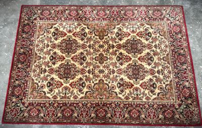 a red and beige rug on a grey floor