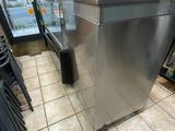 a stainless steel counter in the middle of a restaurant