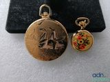 a small gold pocket watch and a small gold pocket watch