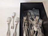 a black box with silverware in it on a table