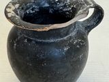 un vase noir posé sur une table