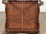 a wooden cabinet that has a door on top of it