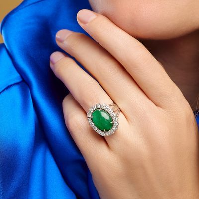 close up of a woman ' s hand with a ring on her finger