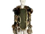 a mannequin dressed in a fur and leather outfit