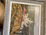 two paintings on display in a box on the floor