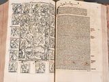 an open book with drawings on it on a table