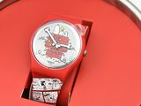 a red watch sitting on top of a red table