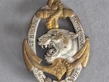 an image of a silver and gold brooch with a lion on it