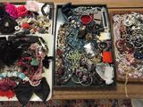 deux plateaux remplis de bijoux variés posés sur une table
